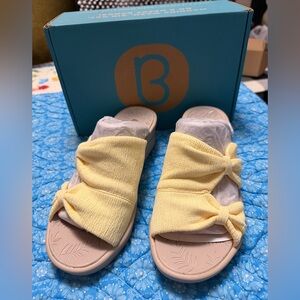 Bzees Smile wedge sandals with a yellow stretch fabric upper and knotted bow